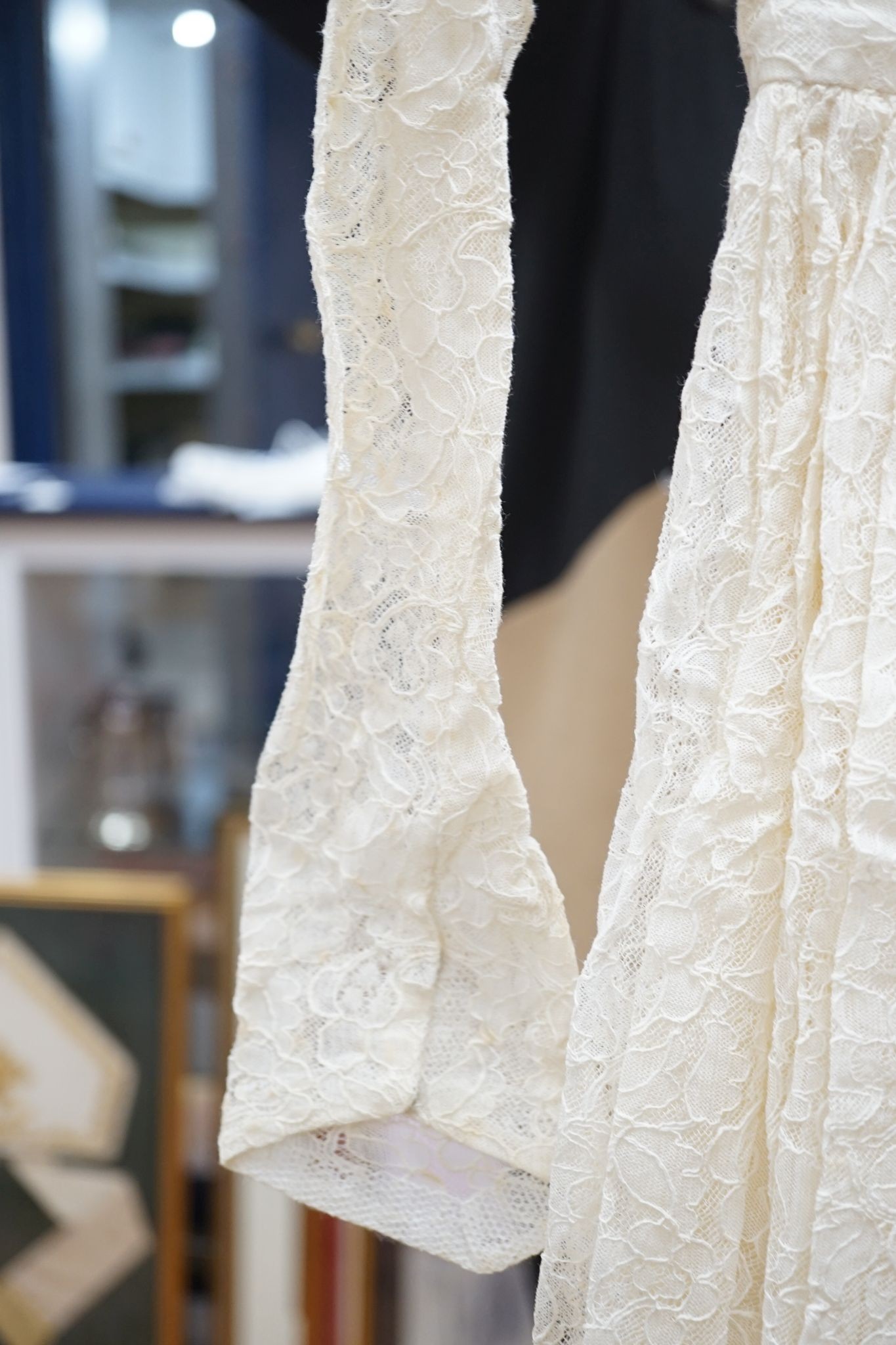 A late 1930's- 40's cream machine lace wedding dress and petticoat together with a pear listed floral tiara/ headdress.